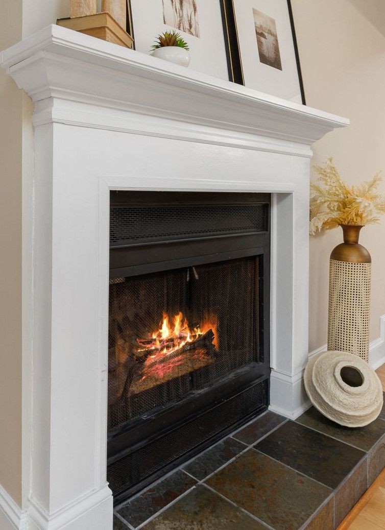 Elegant living room interior featuring a lit fireplace and decorative shelving.